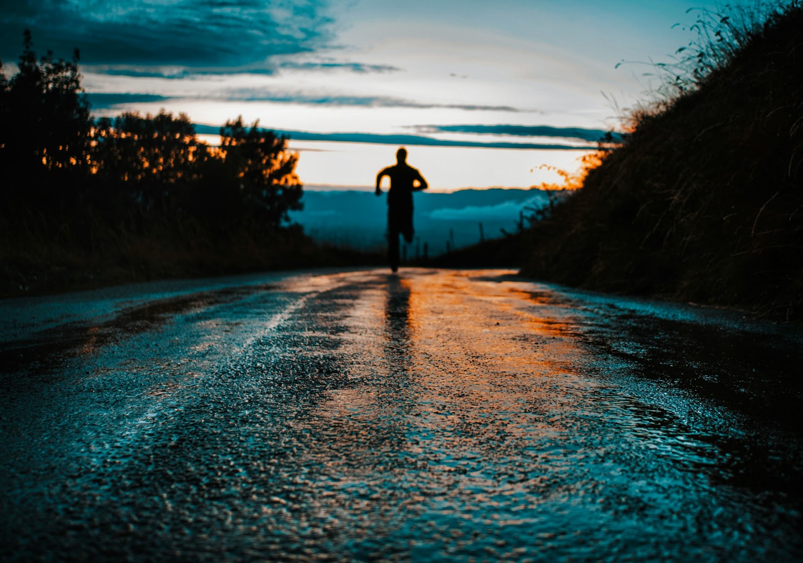 A person running on a wet road