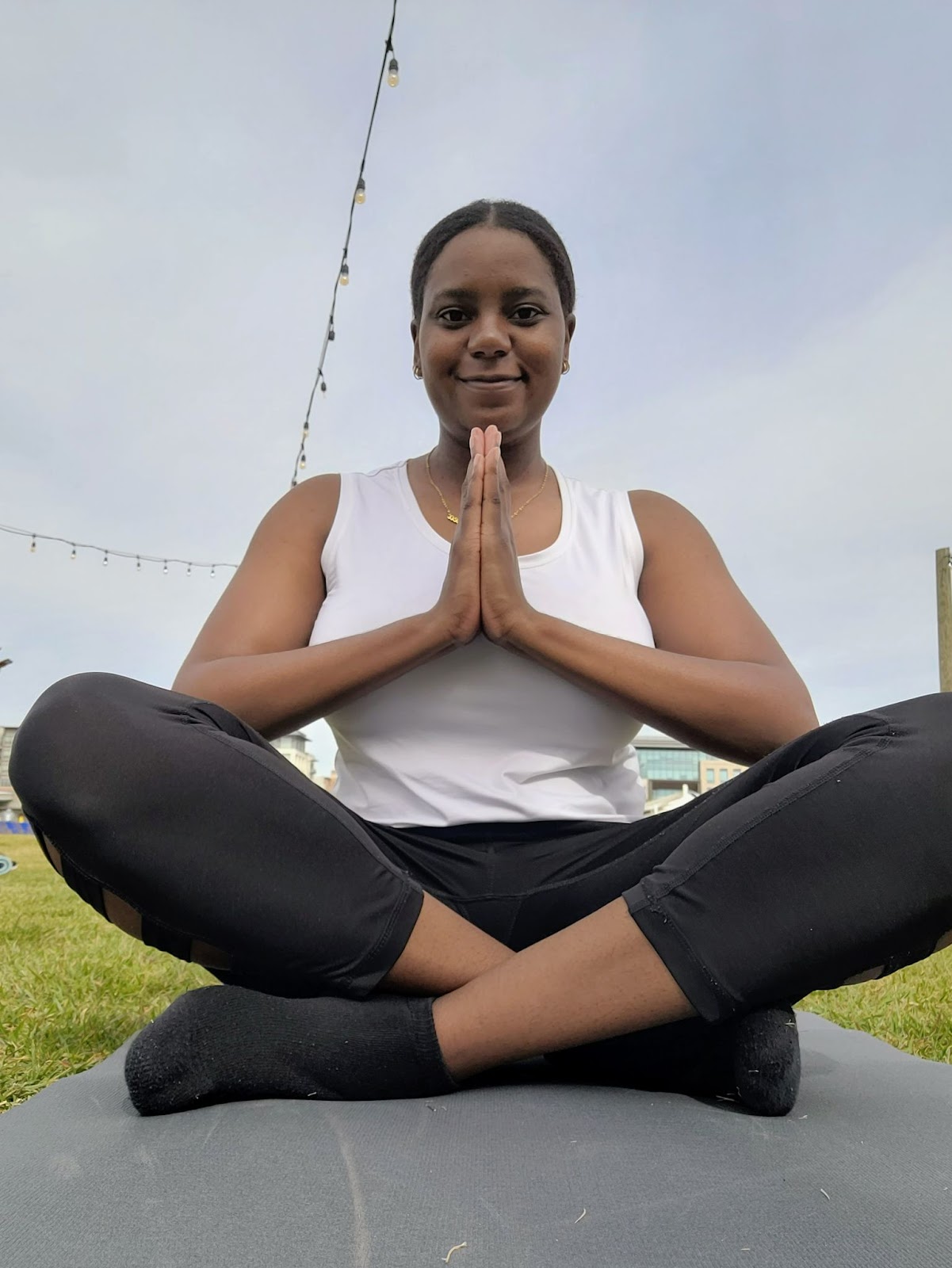 A picture of a black woman doing a yoga pose