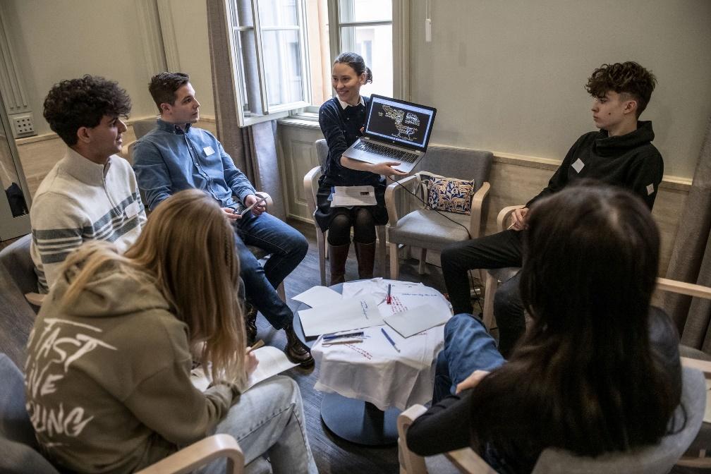 May be an image of 6 people, people studying, table, phone and text