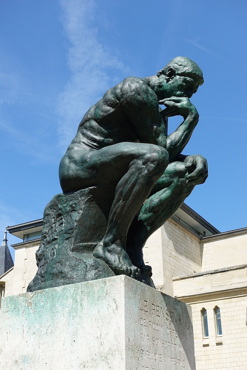 A photo of the Rodin statue, a man thinking… but also he’s naked