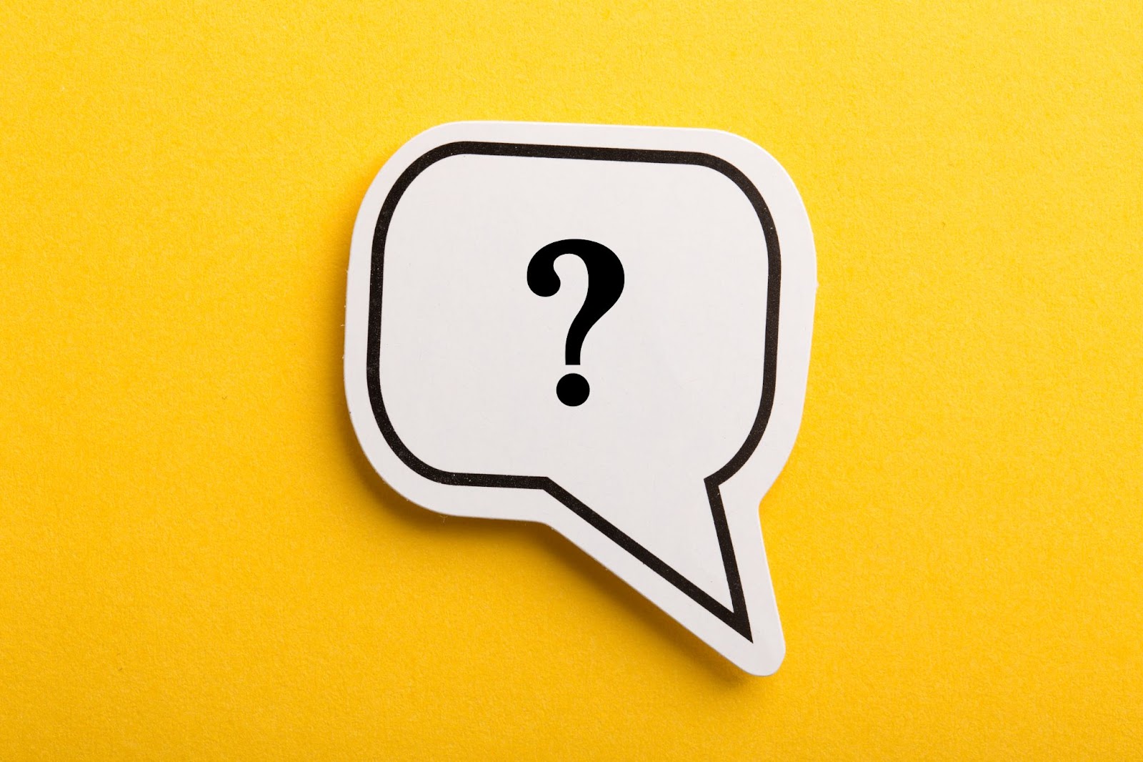 A question mark hovering about a bright yellow background.