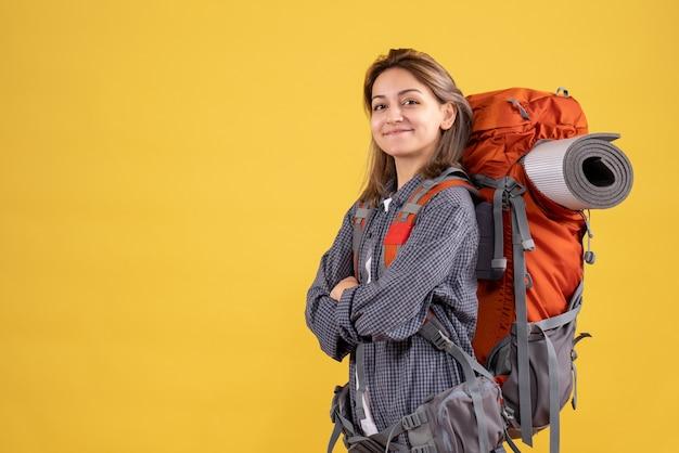 Free photo front view of confident traveler woman with red backpack crossing hands