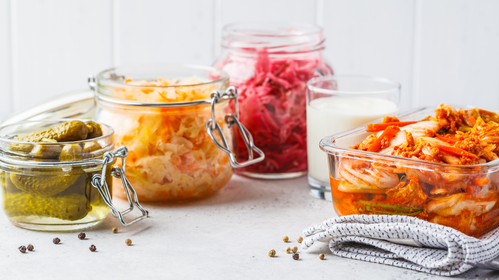 A photo of fermented foods. What are the benefits of taking probiotics? 