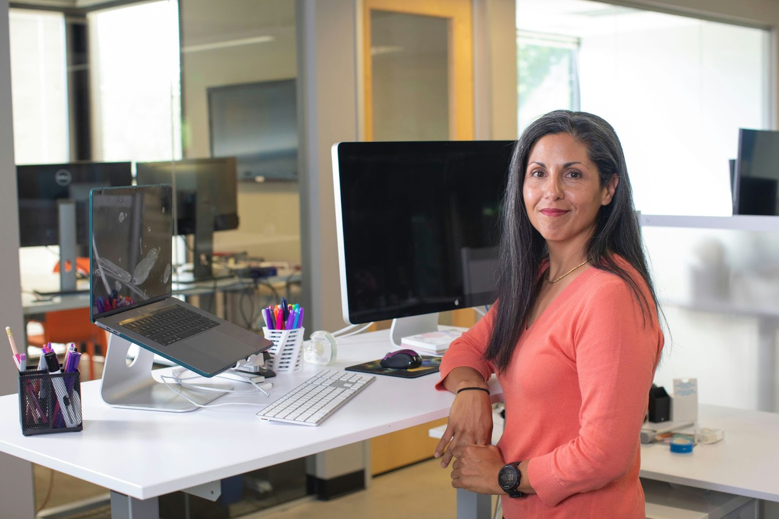 A woman standing in her work cabin is giving a side pose for her business headshots