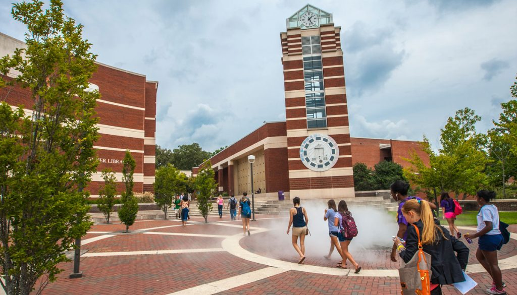 Exterior view of Joyner East building at East Carolina University Brody School of Medicine, a multi-story red brick building with large windows and a courtyard in front.