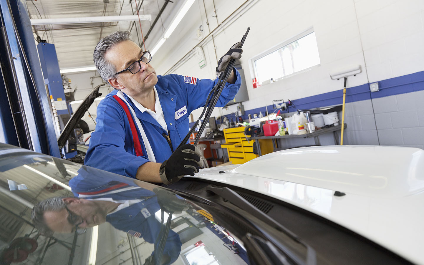 Auto expert routinely checking the car wiper blades
