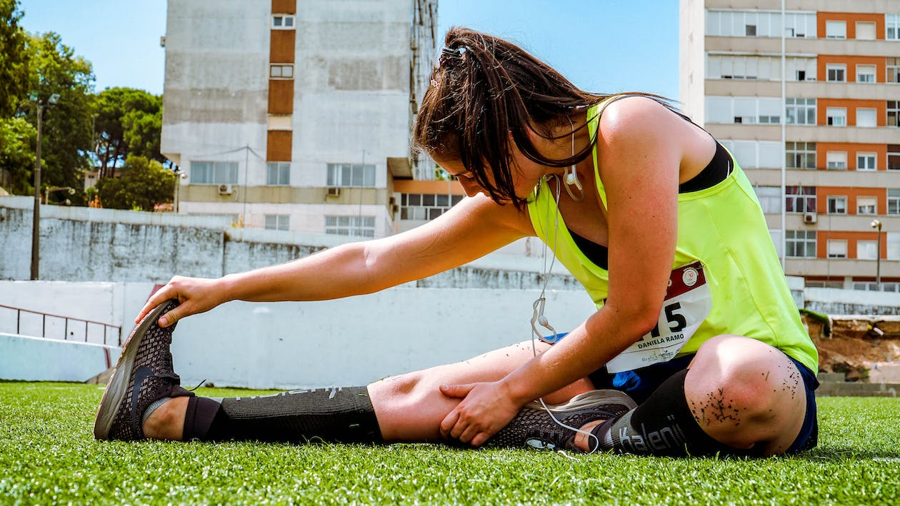 a woman stretching after running in a race