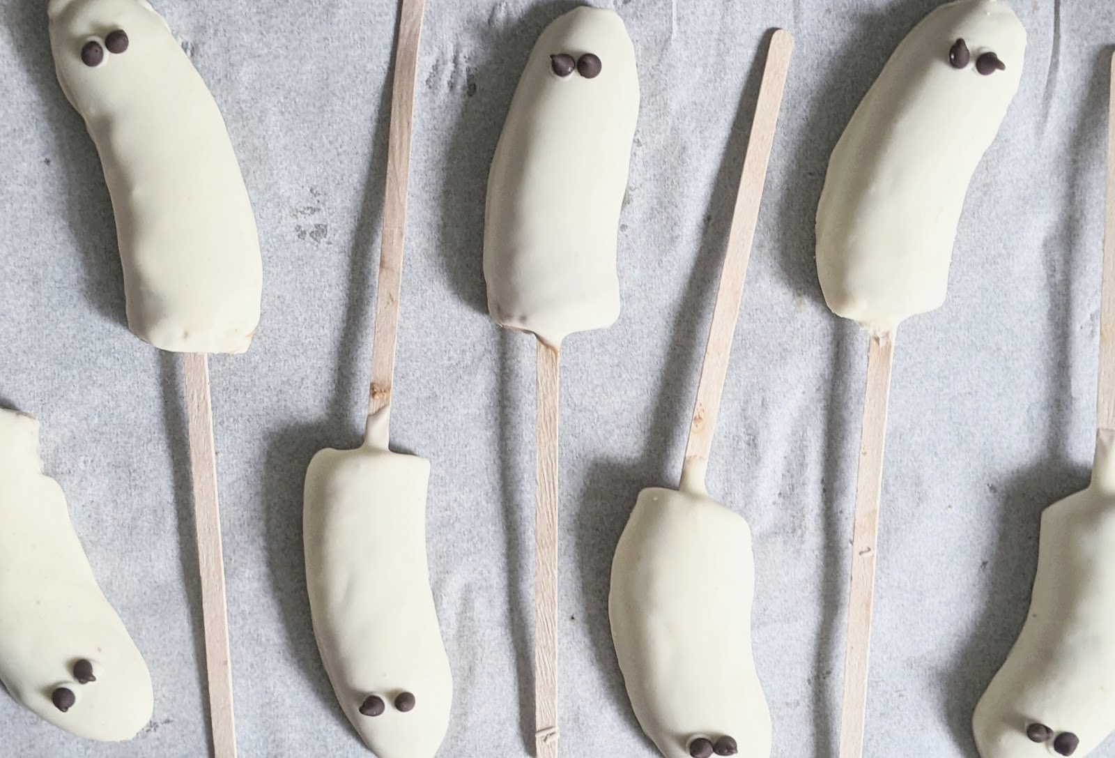 top down view of ghost pops with two chocolate chip eyes on each