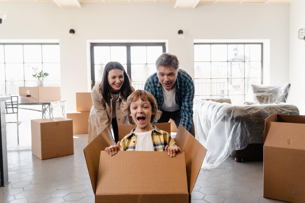  Parents playing with their son while packing.