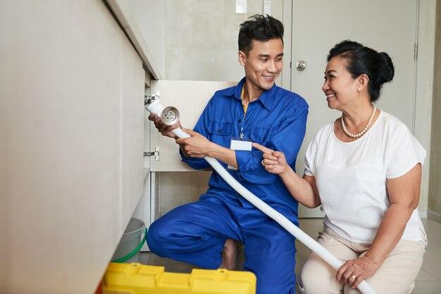 Handyman helping senior woman in kitchen