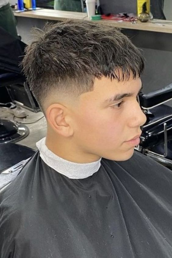 Full picture of a guy in the salon rocking a textured crop