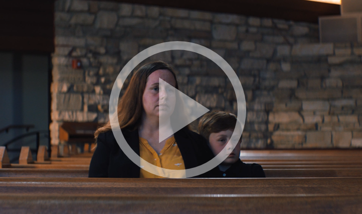 A person and two children sitting in pews

Description automatically generated
