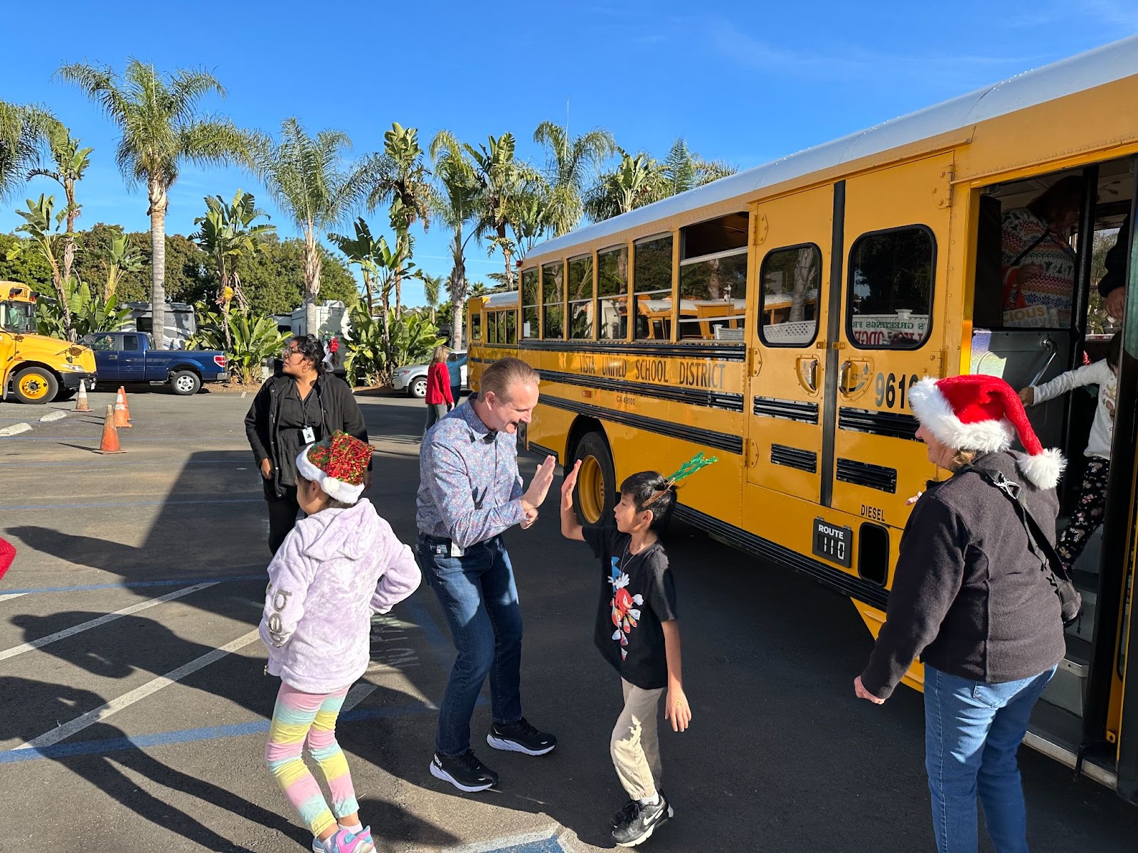 Students Getting Off the Bus Wearing Santa Hats.