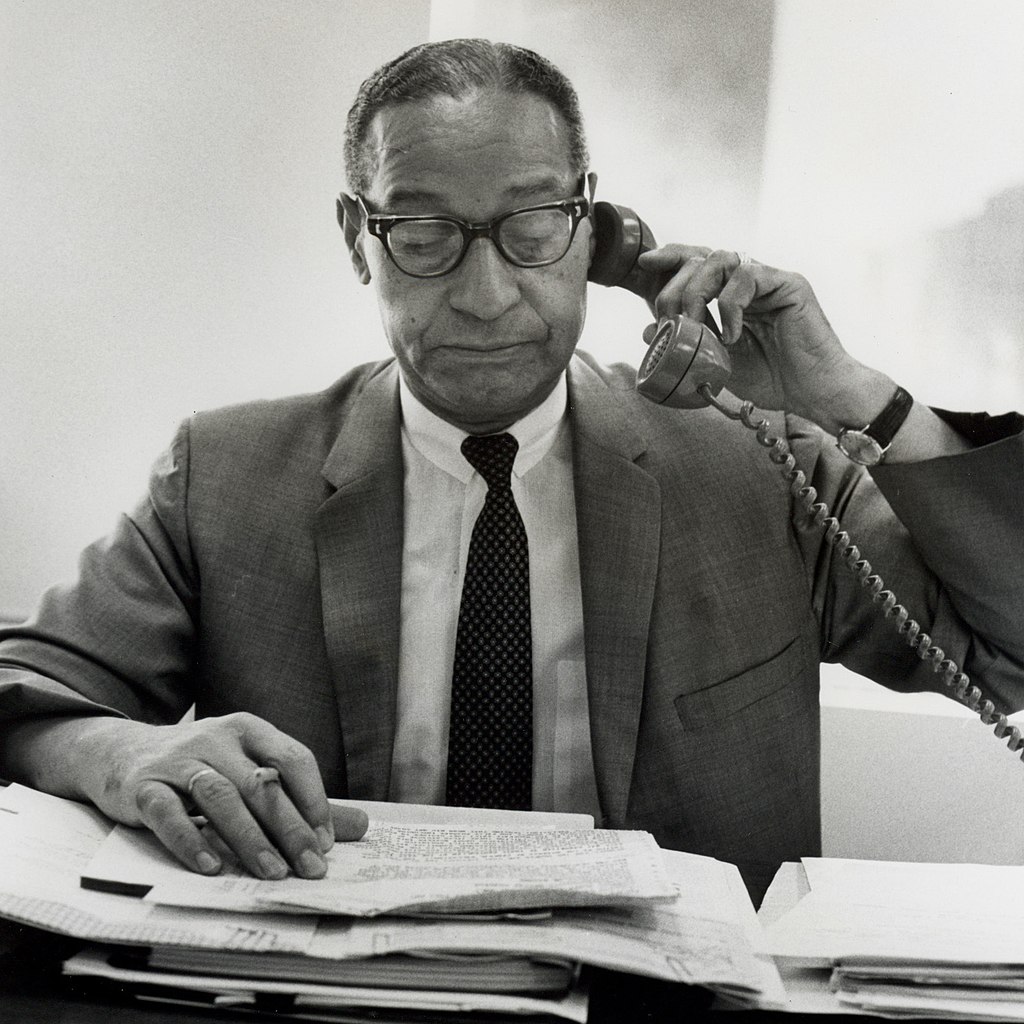 Theodore Berry talking on the phone while at work.