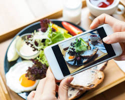 food blogger taking a photo of their food