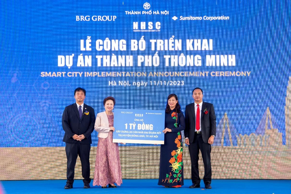 A group of people standing on a blue stage Description automatically generated