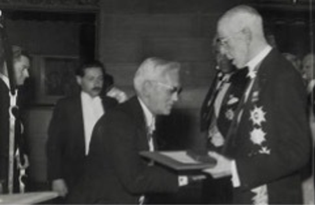 A black and white image of Alexander Fleming receiving the Nobel Prize in Sweden.