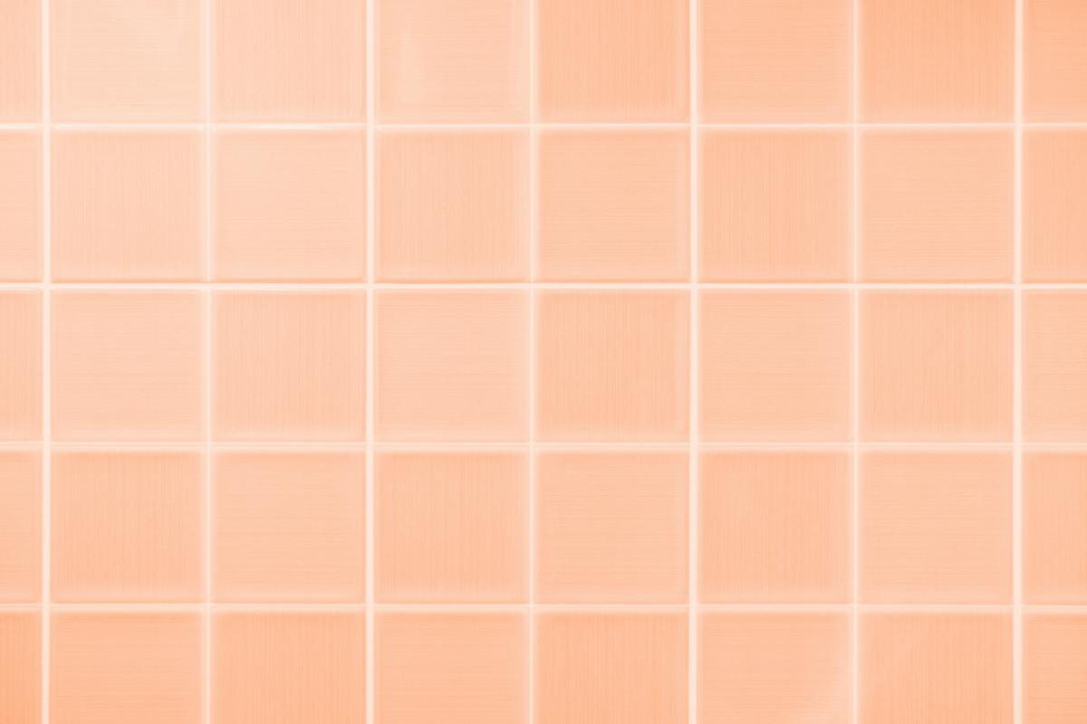 Closeup of bathroom tiles in the Pantone color peachfuzz