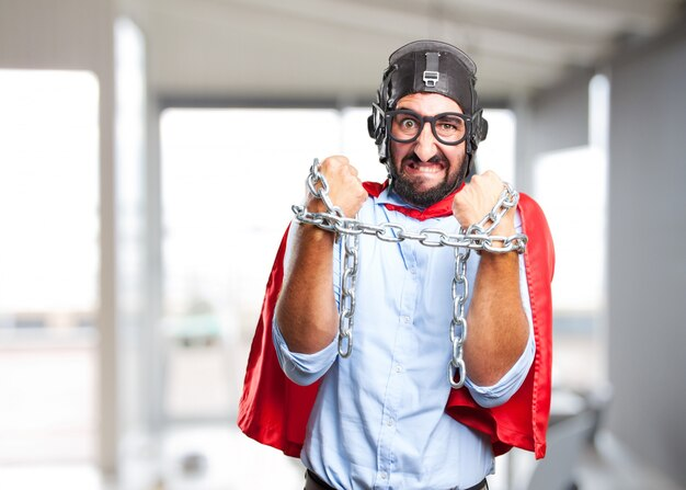 a man with a funny expression trying to break open chains