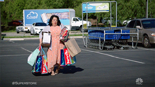 Woman overloaded with shopping bags