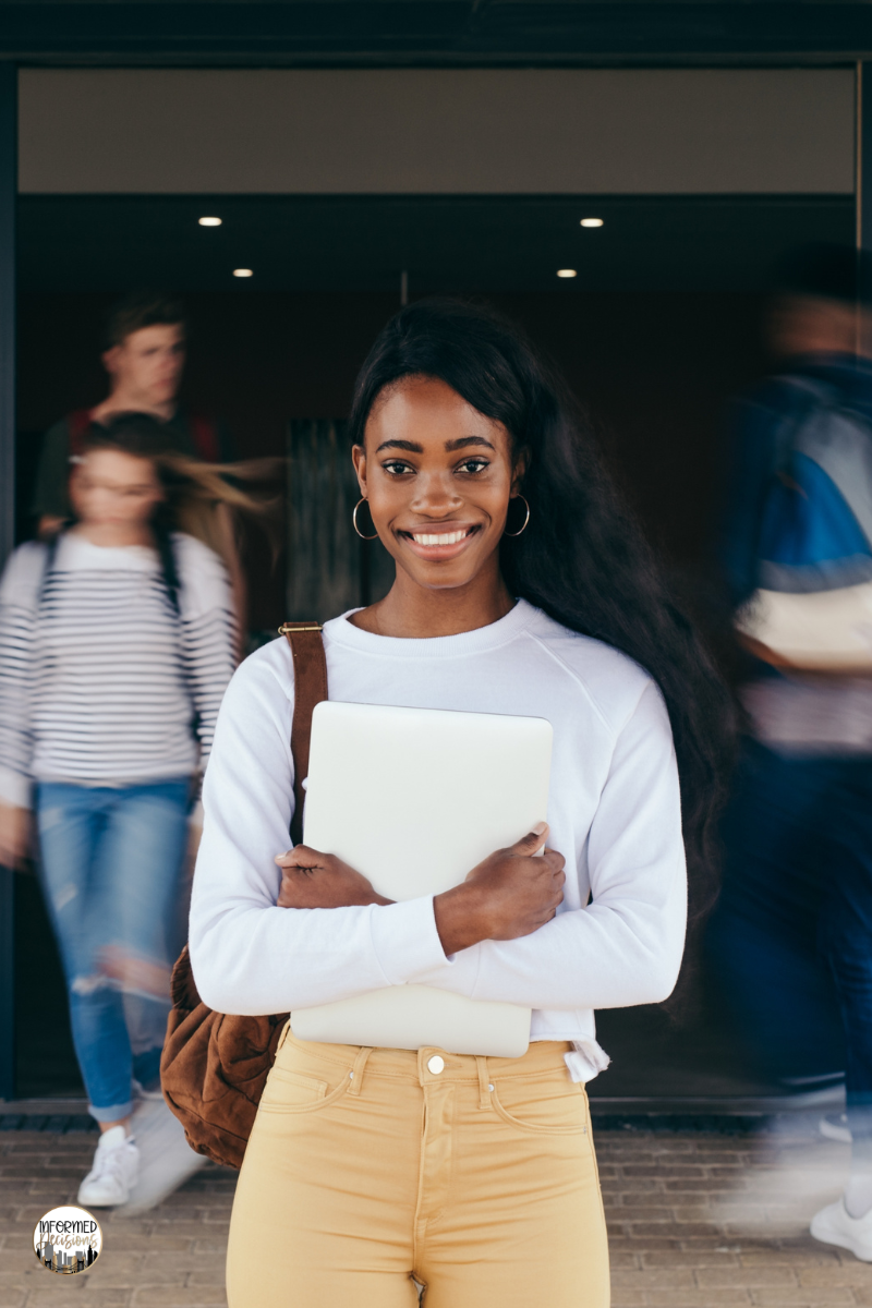 Teen girl holding a book and a bag.