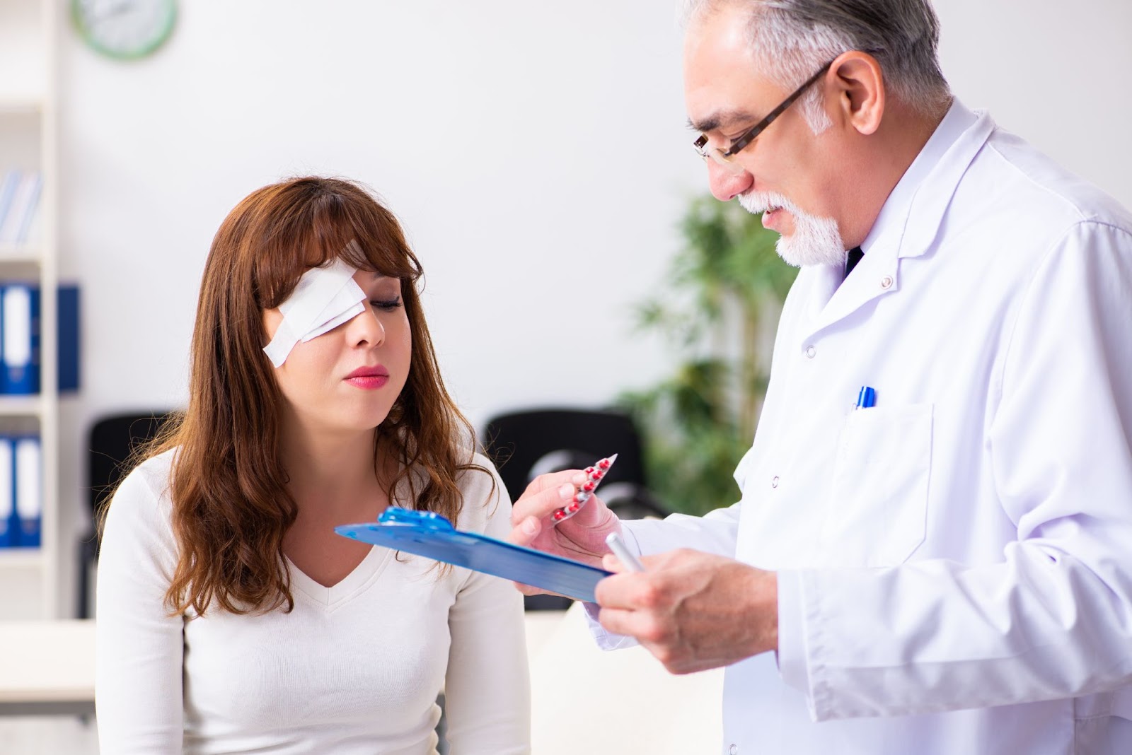 A woman with a patch over her right eye visiting her eye doctor for a follow-up appointment after laser eye surgery
