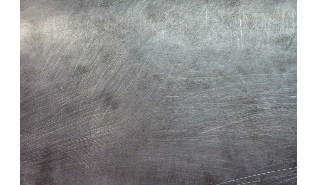 Scratches sprawled across a zoomed in metal surface.