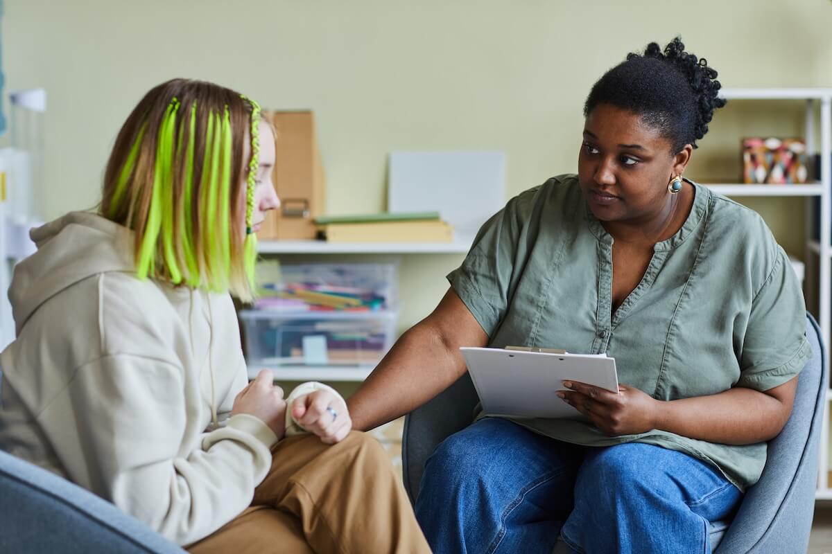 Child and family services EHR: social worker talking to a girl