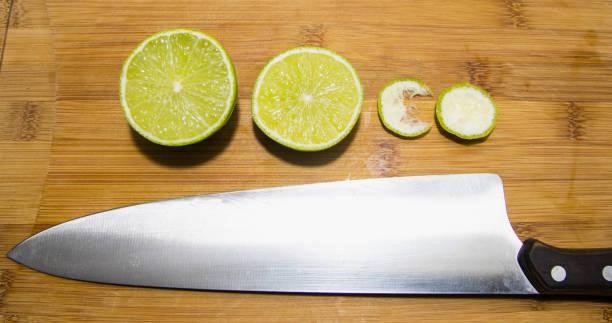 lemon sliced with a cook knife on a wood cutting board Civivi Elementum knife stock pictures, royalty-free photos & images