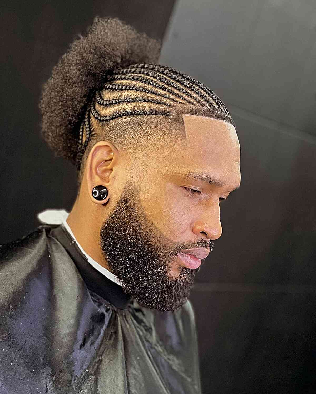 Braids For Men: Picture showing a guy rocking some cornrows with the afro puff