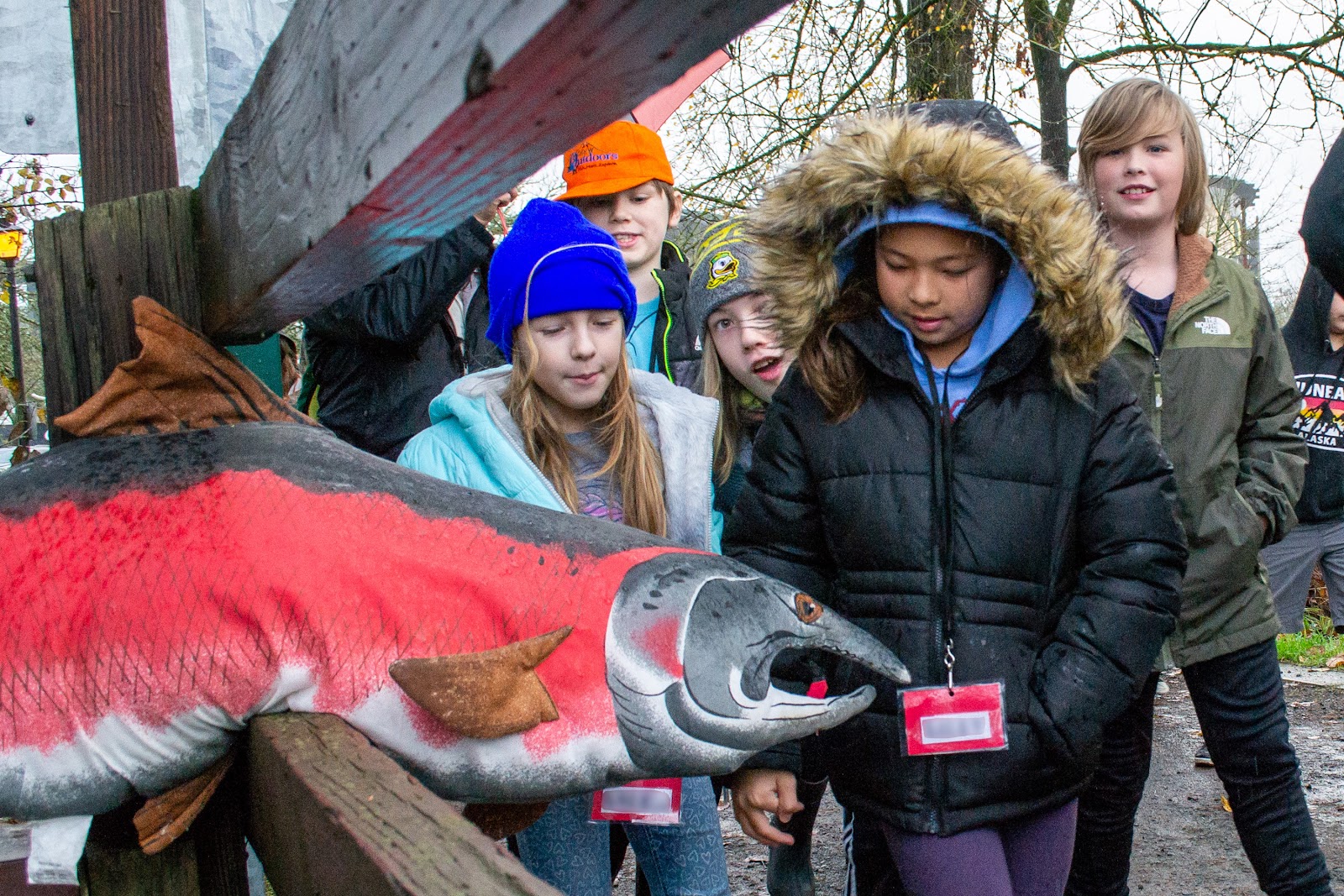 Students greet plush salmon