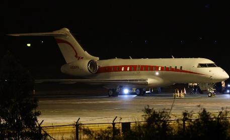 A plane on the runway at night

Description automatically generated