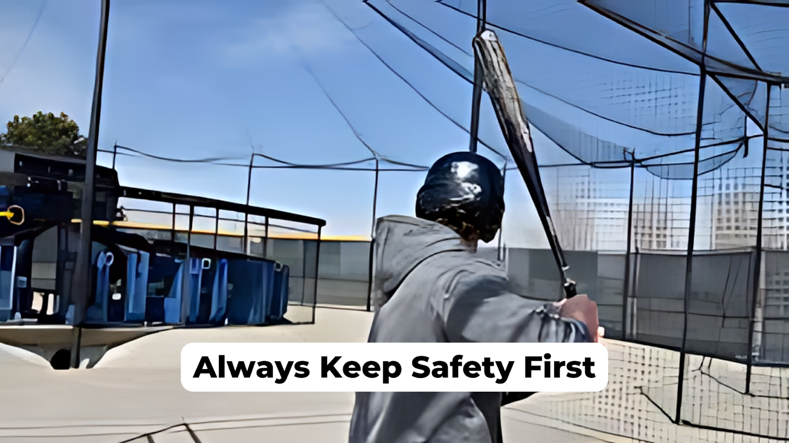 A baseball player wearing helmet inside a backyard batting cage