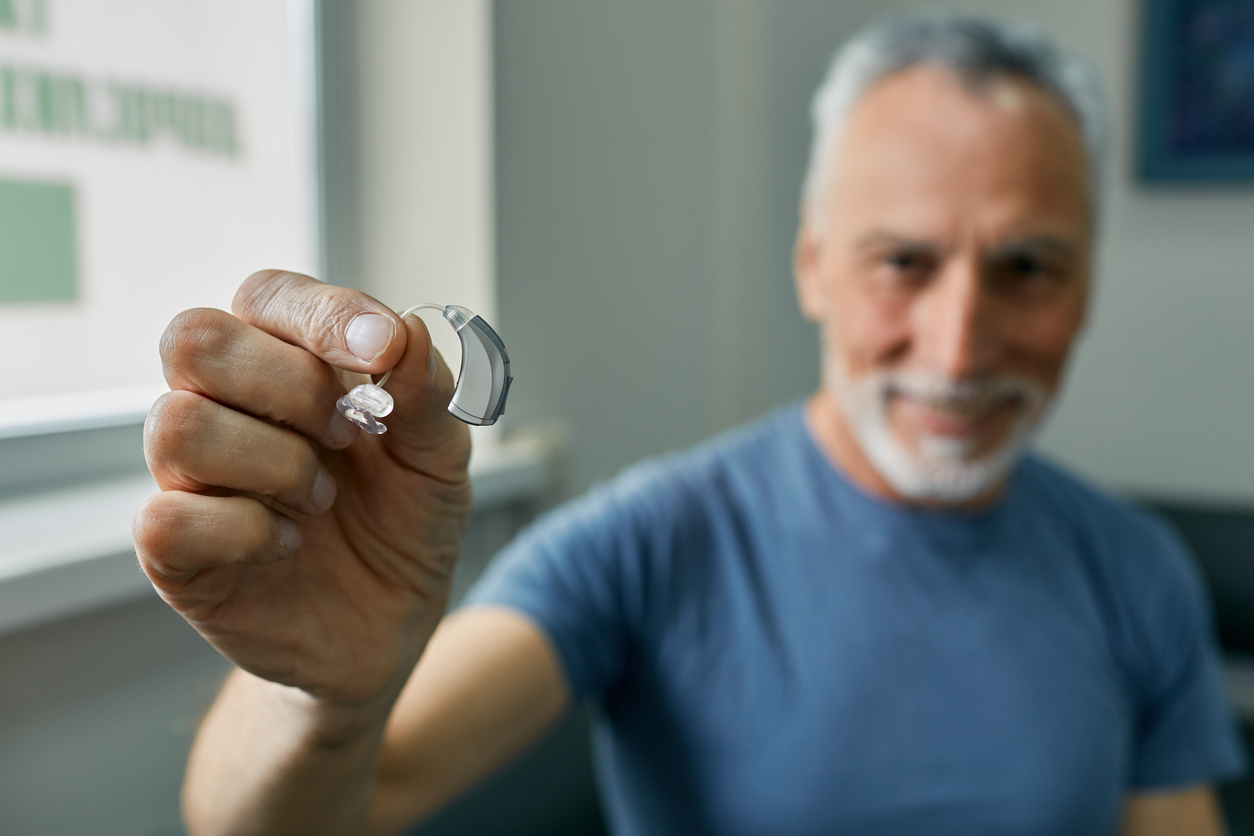 old man with hearing aid