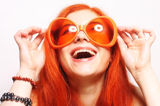 Woman With Red Hair and Big Orange Glasses Laughing 