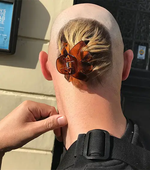Back view of a man using the clip at the back of his head