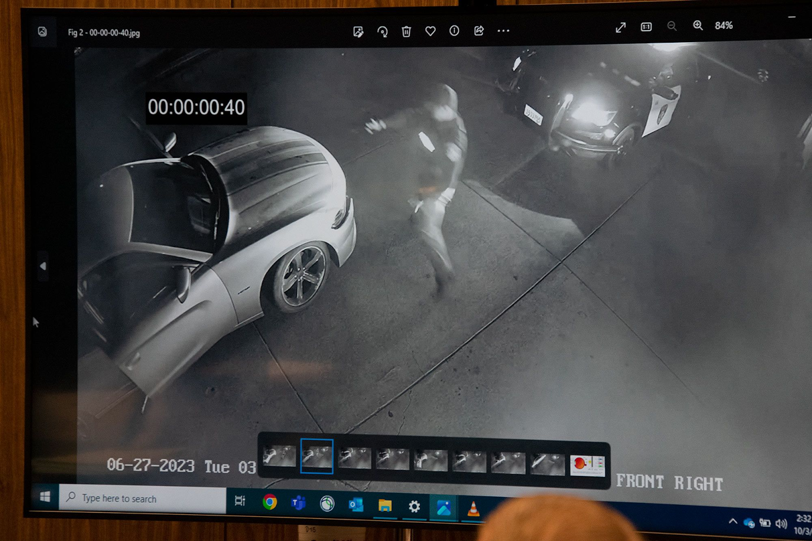 A still from surveillance video shown in court shows that Jamazea Kittell had already started moving away from Officer Brad Kim before Kim crossed in front of his vehicle. 