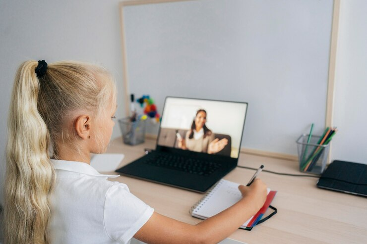 Attentive young girl participating in an online class, embracing inclusive education.