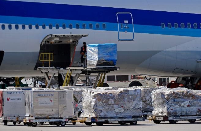 Airline workers load cargo into an All Nippon Airways passenger plane at Los Angeles International Airport on October 30, 2010 in Los Angeles, California.