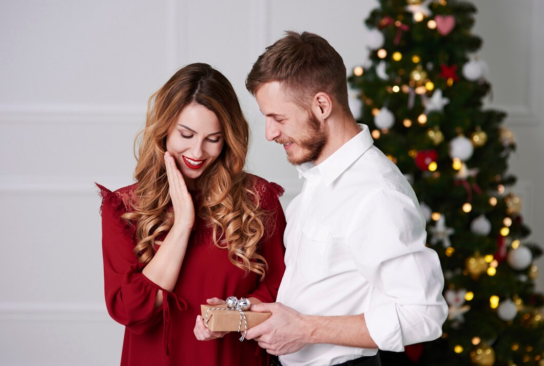 A man giving an engagement ring to his girlfriend on Christmas. 