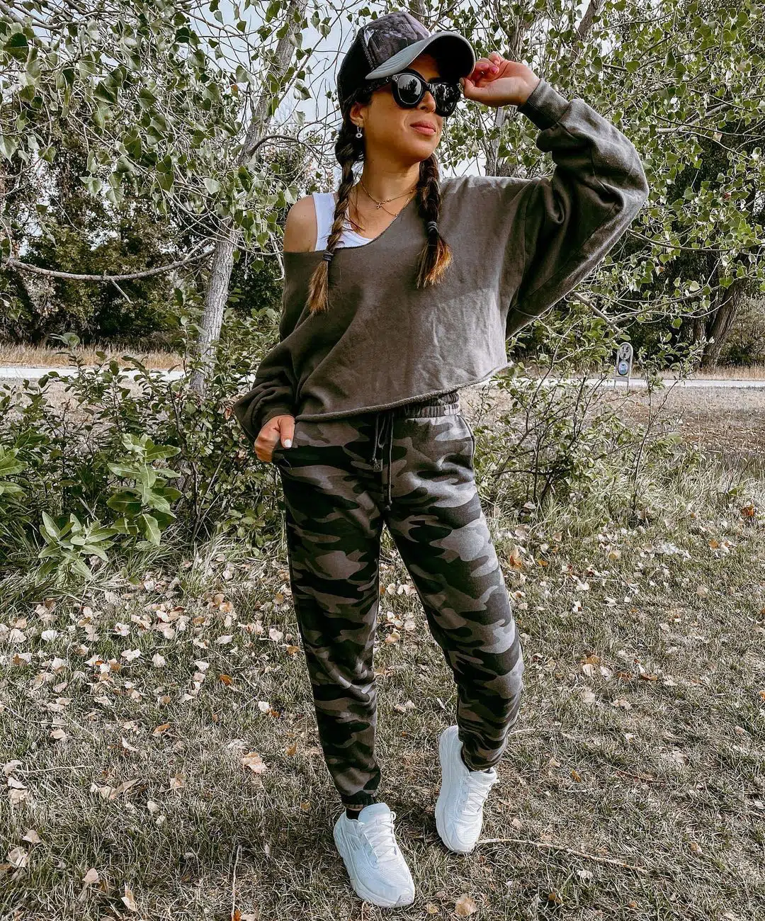 Soccer mom outfit: Picture showing a lady rocking an off the shoulder to with camo pants for a trendy look