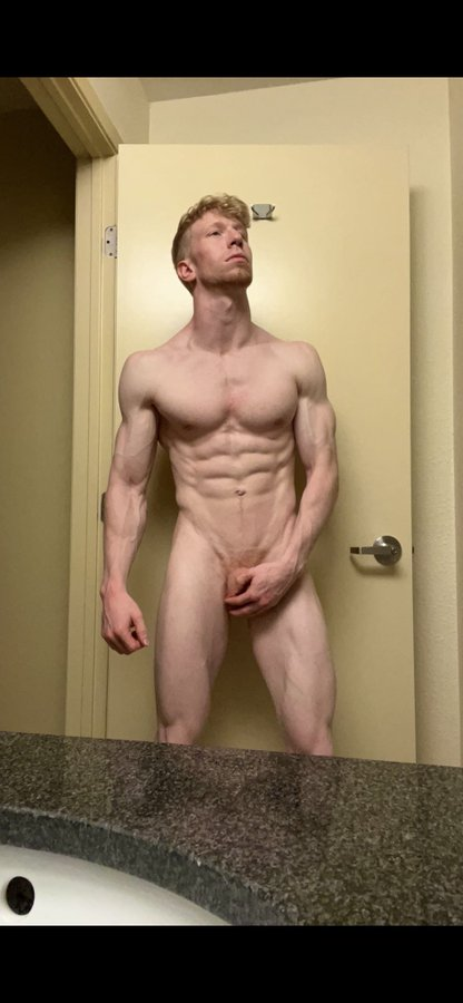 Jesse Stone standing naked for an iphone mirror covering his flaccid cock