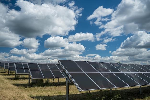 Solar panels used for renewable energy on the field under the sky full of clouds