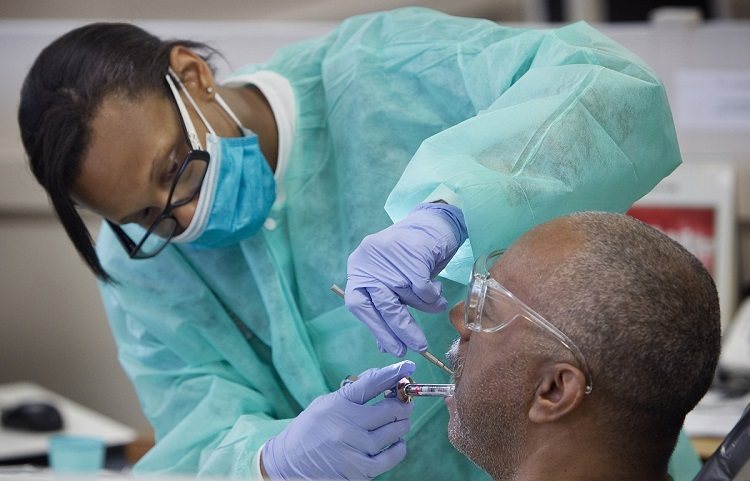 A photograph showcasing the Meharry Medical College School of Dentistry clinic, a bustling environment where dental professionals treat patients and dental students gain hands-on experience.