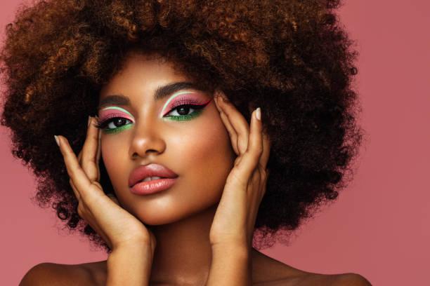 portrait of young afro woman with bright make-up - black woman stock pictures, royalty-free photos & images