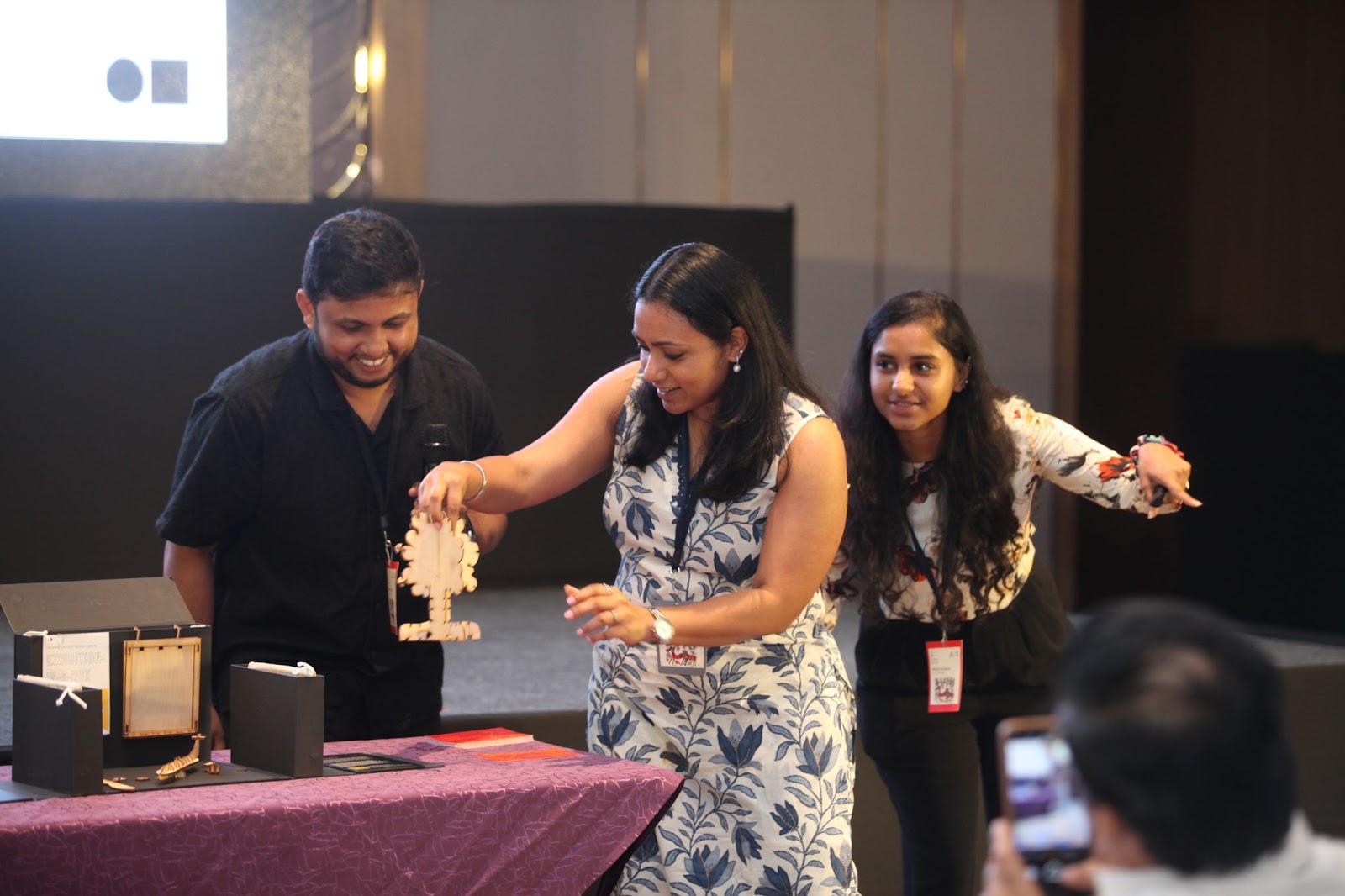 A participant from the 16th Young Investigators’ Meeting (YIM 2024) interacting with the box on the exhibit ‘Foresta Inclusive’ from the Carbon exhibition. Photo credits: IndiaBioscience