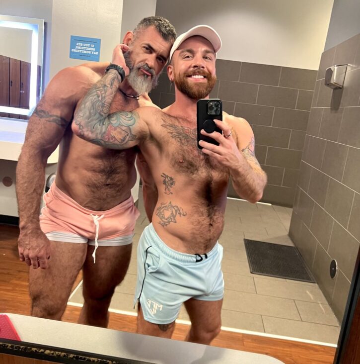 Lawson James pouting and posing with a gay xxx onlyfans creator at the gym and wearing slutty circuit shorts