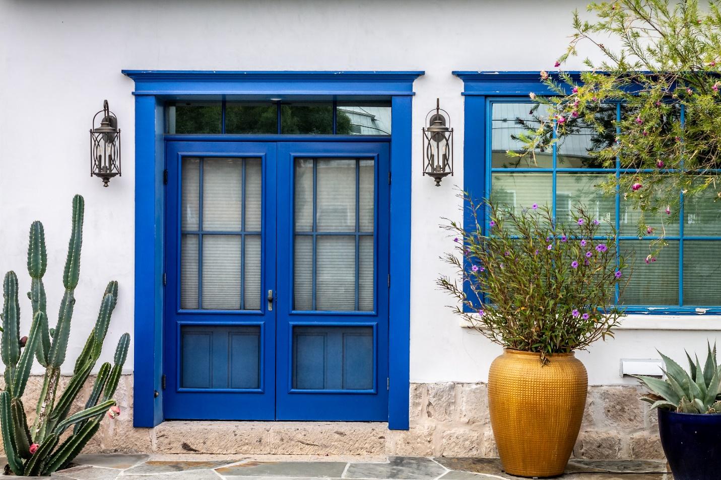 A blue door and window with plants in front of it

Description automatically generated