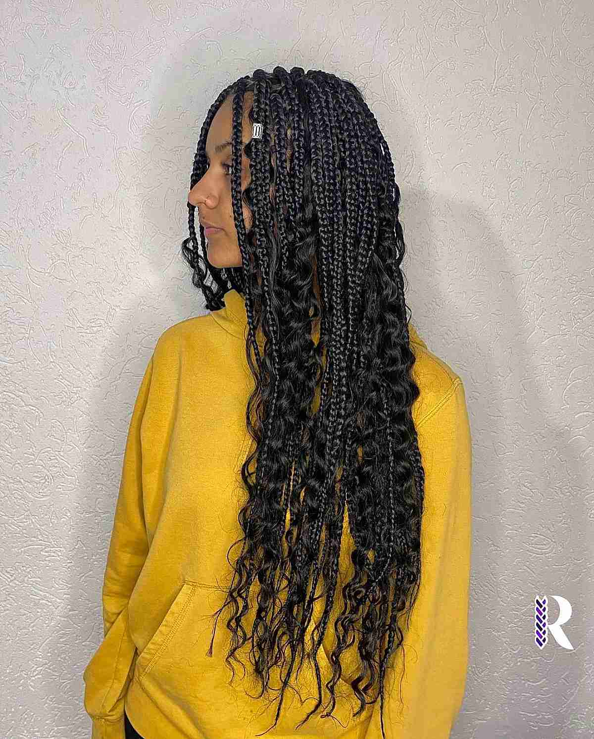 Side view of a lady wearing Loose Curls with Goddess Braids