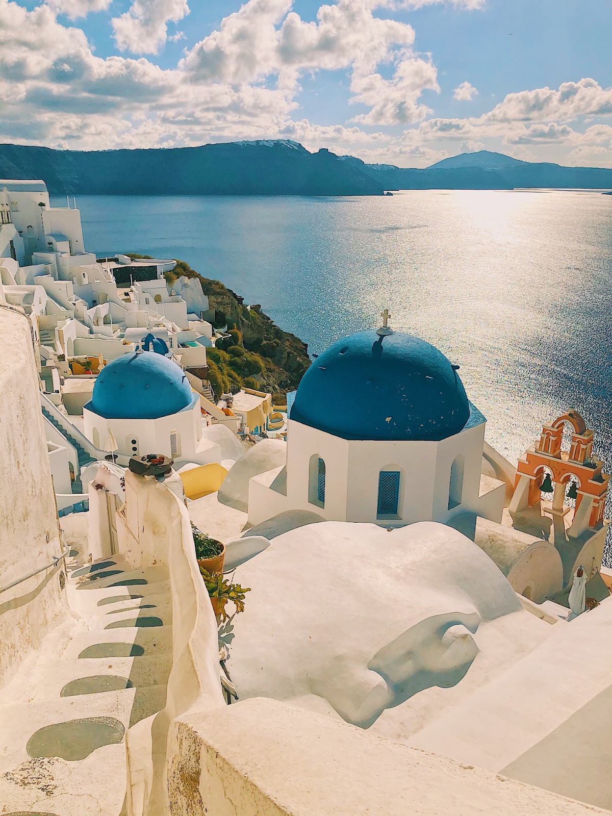 A view of white and blue buildings near the sea in Santorini.